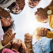 Cropped shot of a group of friends holding hands